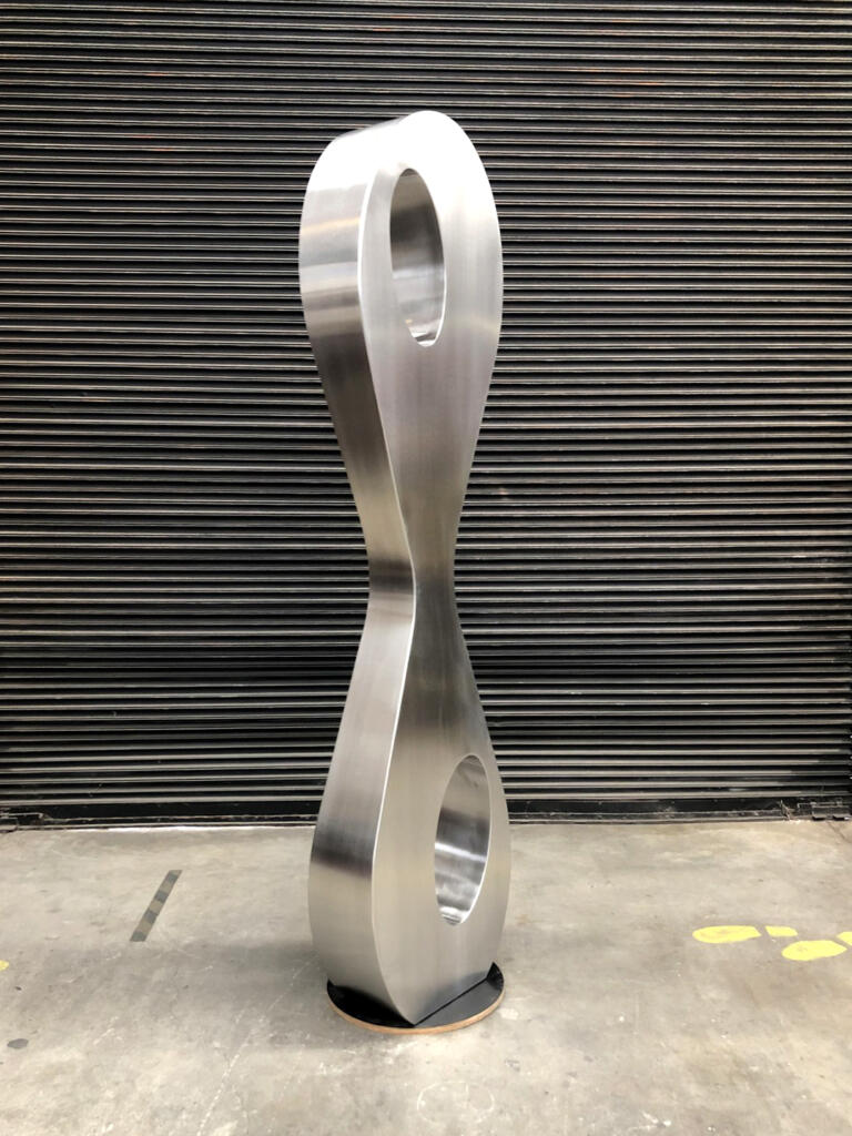 Tall Curvy Stainless Steel sculpture made by Lump Sculpture Studio