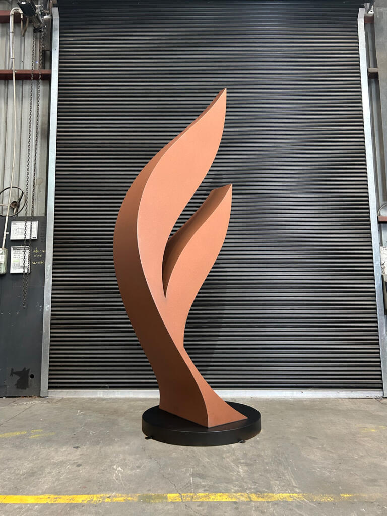 Dicot is a contemporary sculpture by Lump, crafted from Corten steel with a rusted patina and stainless steel details, inspired by the forms of plant seeds.