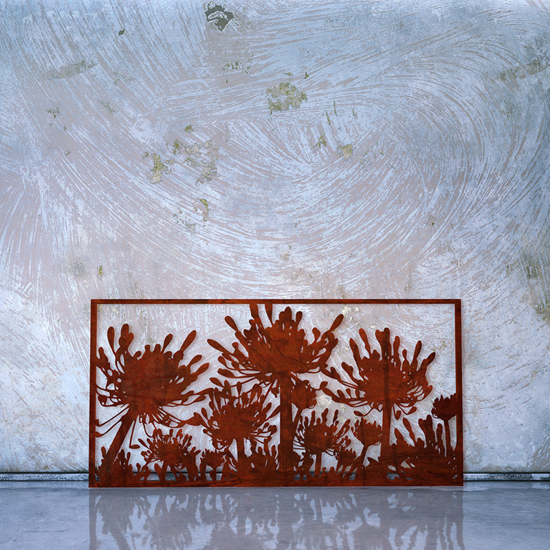 Decorative Rusted Laser Cut Screen made form Corten Steel leaning on factory wall