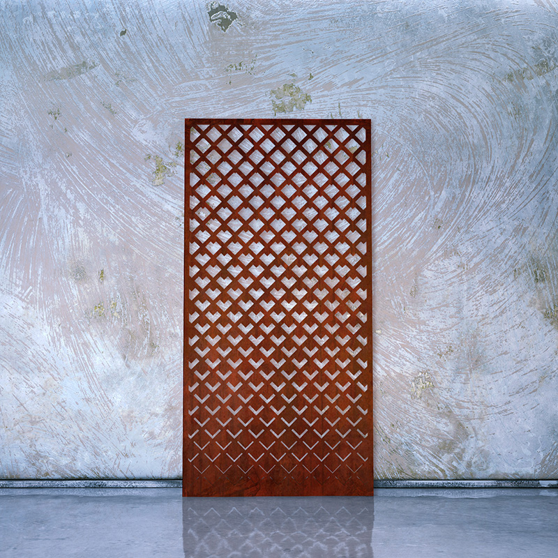 Corten Steel Rusted Laser Cut Screen leaning on Whitewashed Factory Wall