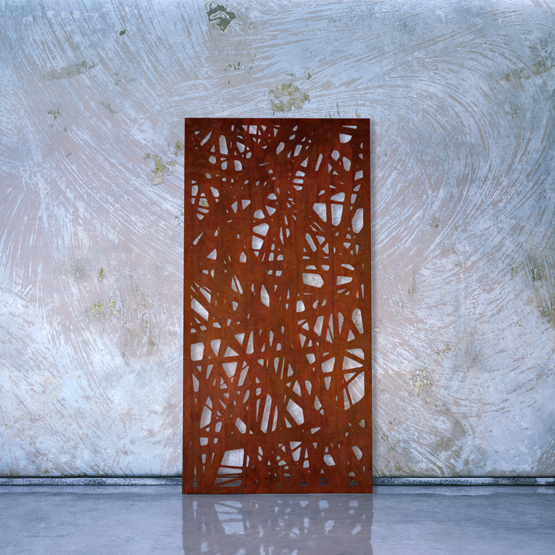 Decorative Rusted Laser Cut Screen made form Corten Steel leaning on factory wall