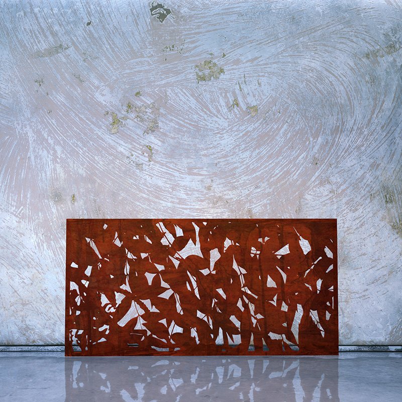 Corten Steel Garden Screen with Rusted finish leaning on whitewashed wall