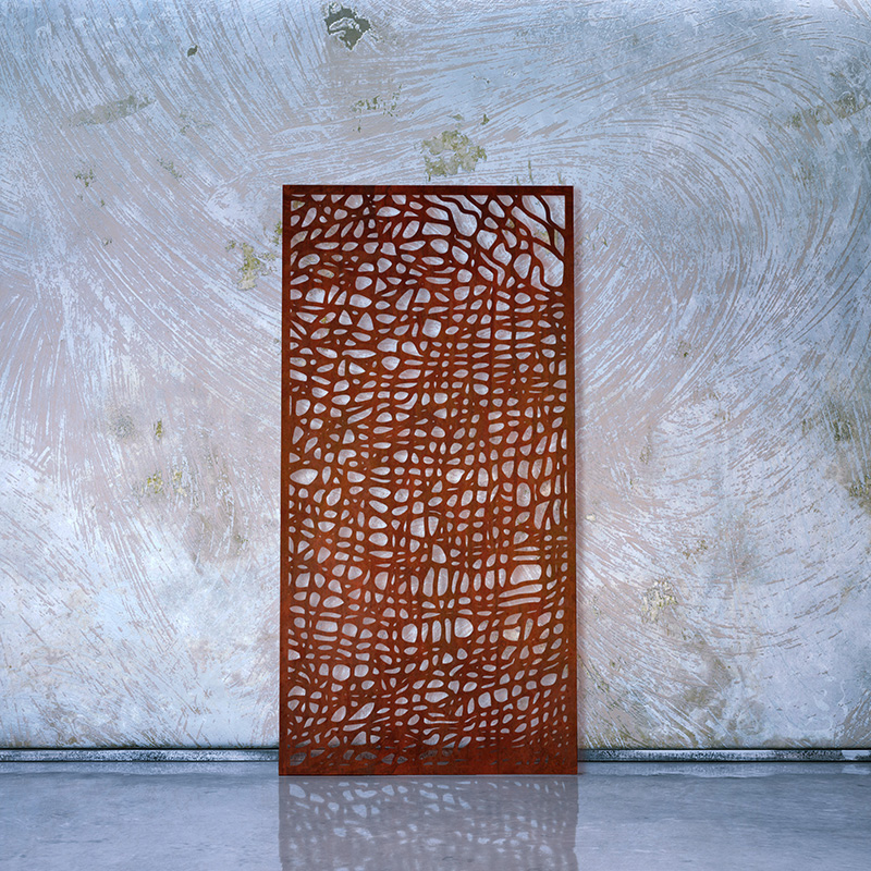 Corten Steel Garden Screen with Rusted finish leaning on whitewashed wall