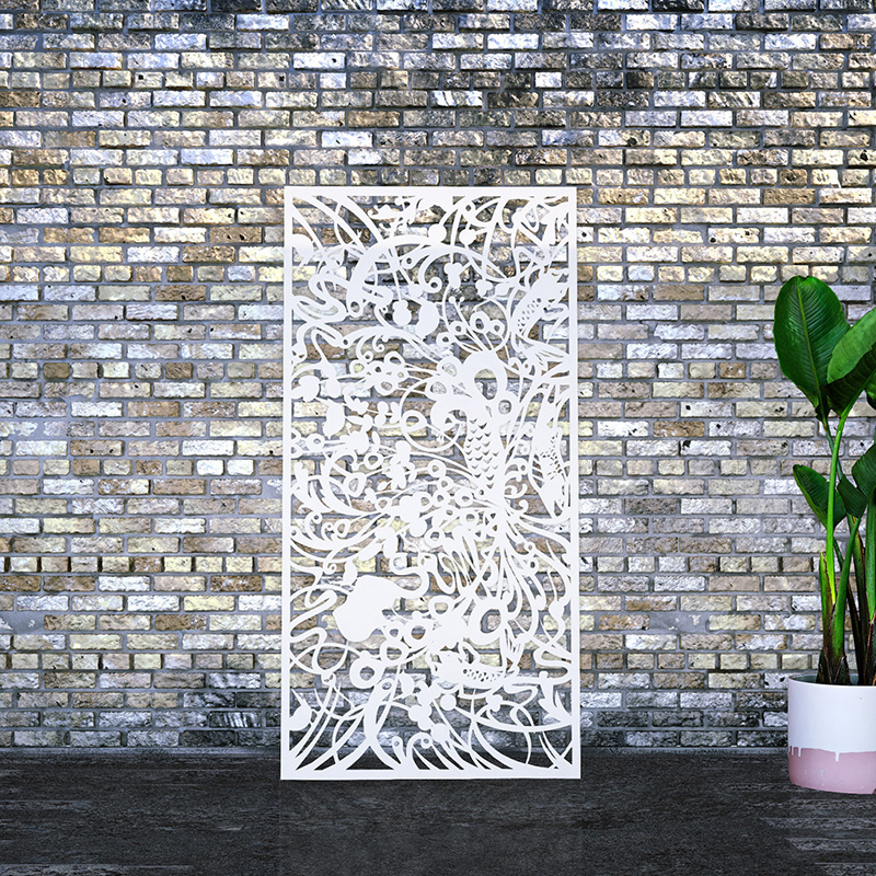 White metal garden screen with decorative screen design leaning on factory wall