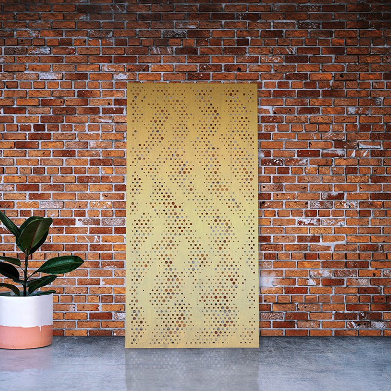 Laser cut Brass Screen leaning on red brick factory wall