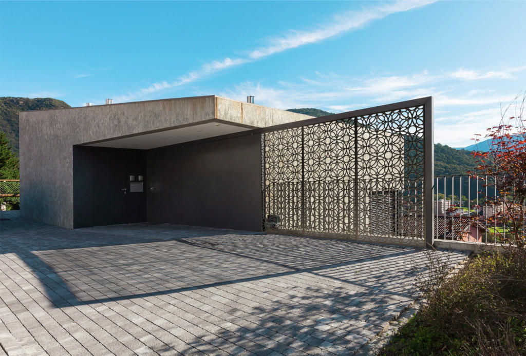 Laser cut privacy screens used as decorative screens and fence at modern architectural house and landscape
