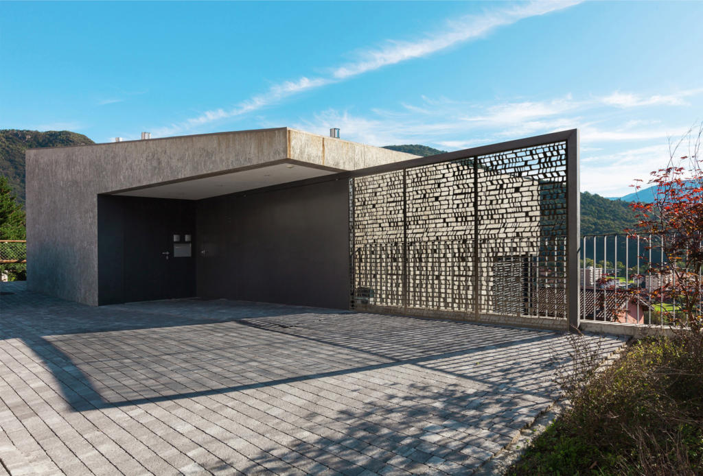 Laser cut privacy screens used as decorative screens and fence at modern architectural house and landscape