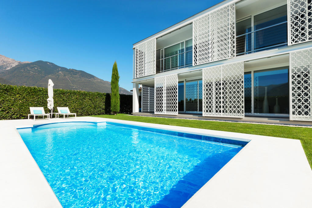 White Laser cut Sliding Screens used as Privacy Screen over windows in modern landscape with pool