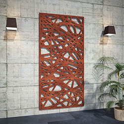 Corten Steel Rusted Decorative Laser Cut Screen leaning on whitewashed factory wall