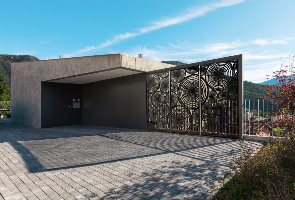 Bronze Laser cut Screens used as a decorative fence featured in modern landscape in Alpine area