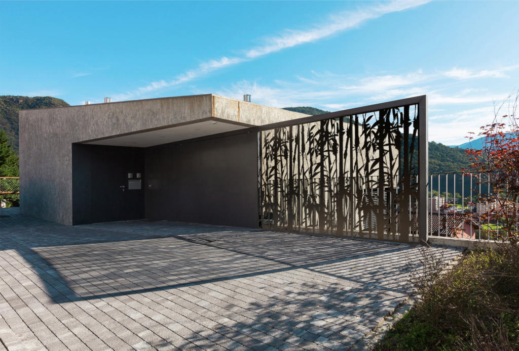 Outdoor screens used as fence and privacy scree at entrance to modern architectural home