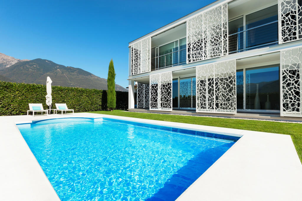 White Laser cut Sliding Screens used as Privacy Screen over windows in modern landscape with pool