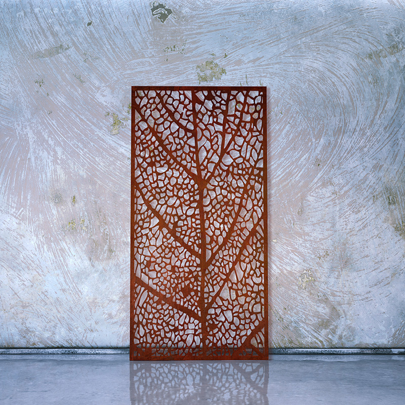 Rusted Metal Garden Screen with laser cut design leaning against wall with whitewashed effect
