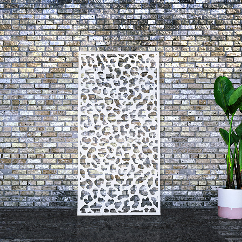 White decorative screen laser cut garden screen leaning against brick wall