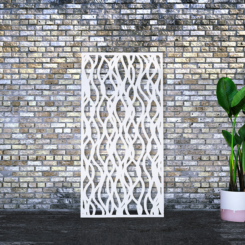 Privacy screen laser cut white steel leaning on factory wall