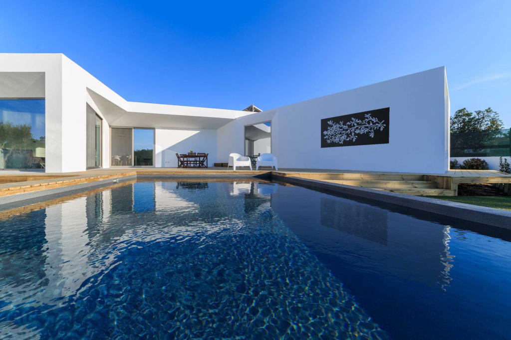 Black laser cut screen with olive branch design featured over a modern pool landscape