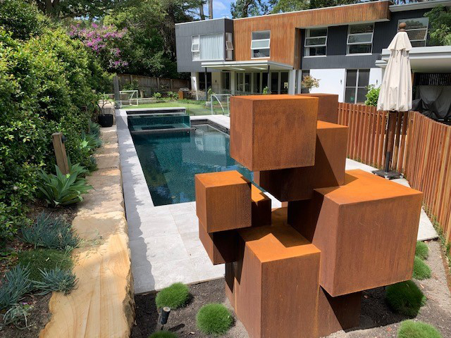 A custom sculpture made from cubes of varying sizes in Corten Steel by Lump Studio