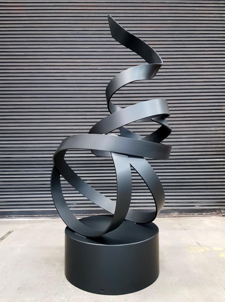 Free flowing black steel sculpture commissioned for residential garden by Lump Sculpture Studio