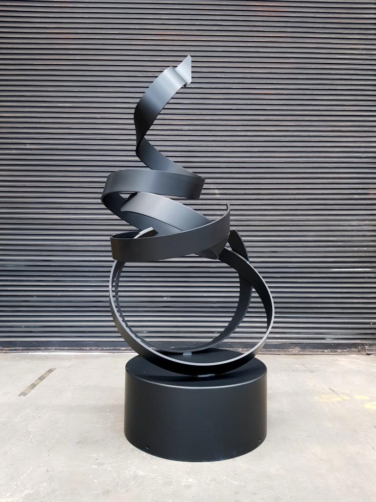Free flowing black steel sculpture commissioned for residential garden by Lump Sculpture Studio