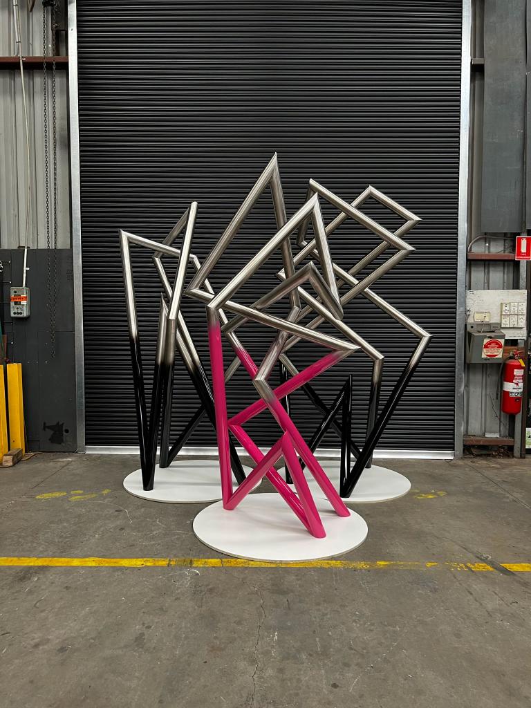 Modern sculpture with Pink detail made from Stainless steel by Lump Studio