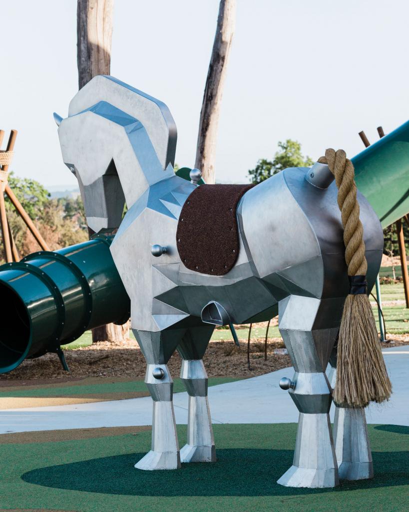 Large Trojan Horse sculpture designed for climbing and riding in a modern playground landscape