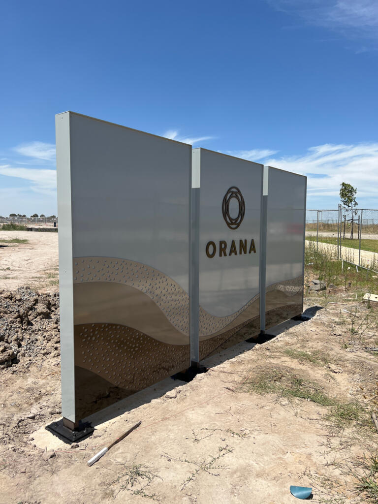 Custom 3D Orana by Balcon signage by Lump Sculpture Studio, creating a bold landmark at the community entrance opposite the Nest sculptures.