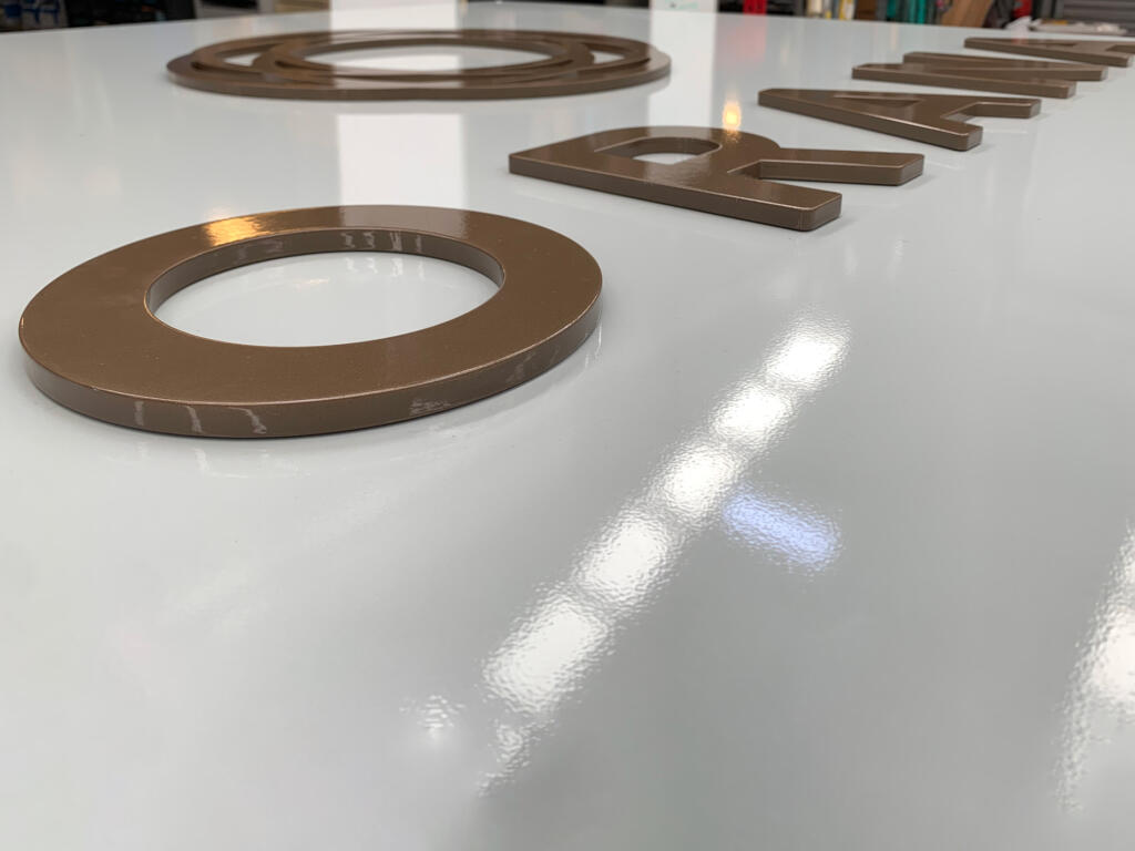 Custom 3D Orana by Balcon signage by Lump Sculpture Studio, creating a bold landmark at the community entrance opposite the Nest sculptures.