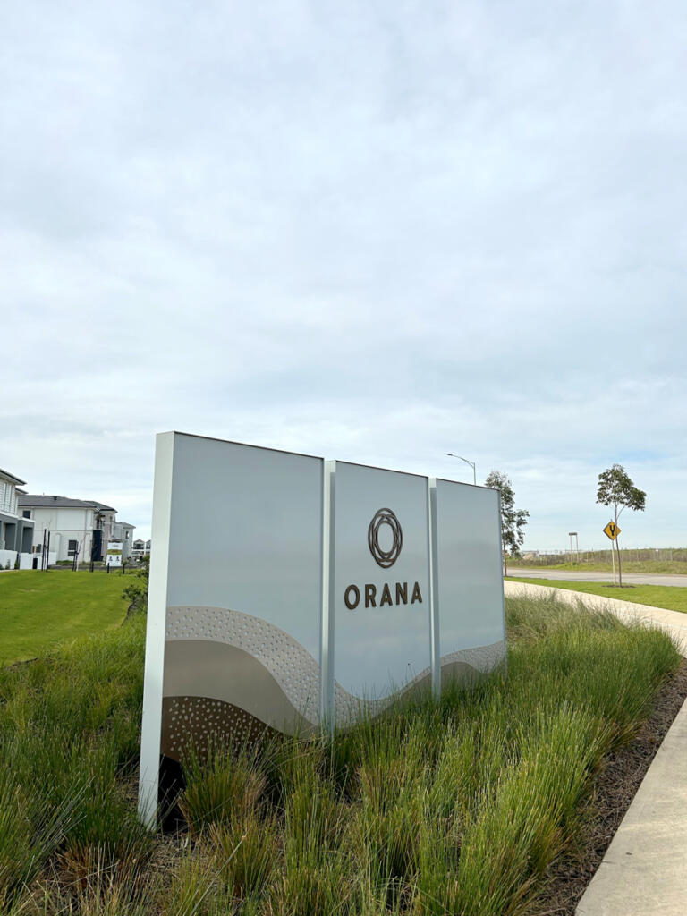 Custom 3D Orana by Balcon signage by Lump Sculpture Studio, creating a bold landmark at the community entrance opposite the Nest sculptures.