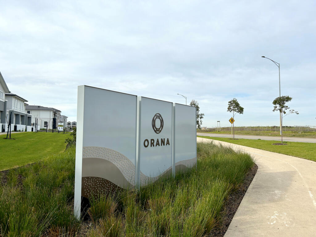 Custom 3D Orana by Balcon signage by Lump Sculpture Studio, creating a bold landmark at the community entrance opposite the Nest sculptures.