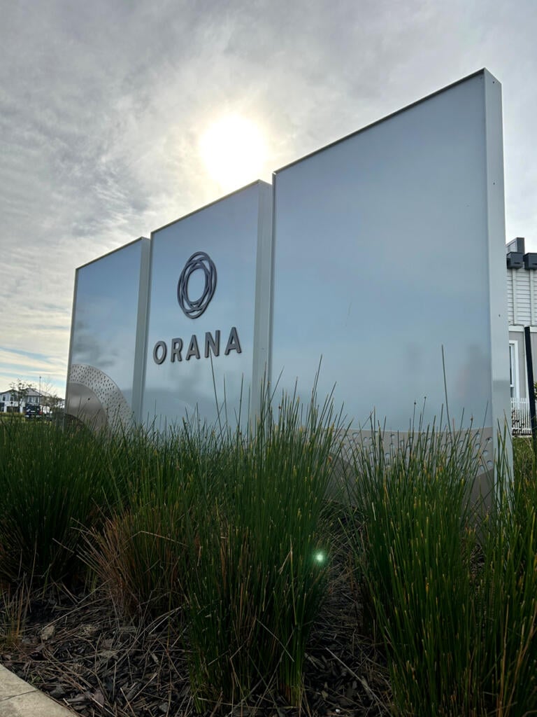 Custom 3D Orana by Balcon signage by Lump Sculpture Studio, creating a bold landmark at the community entrance opposite the Nest sculptures.