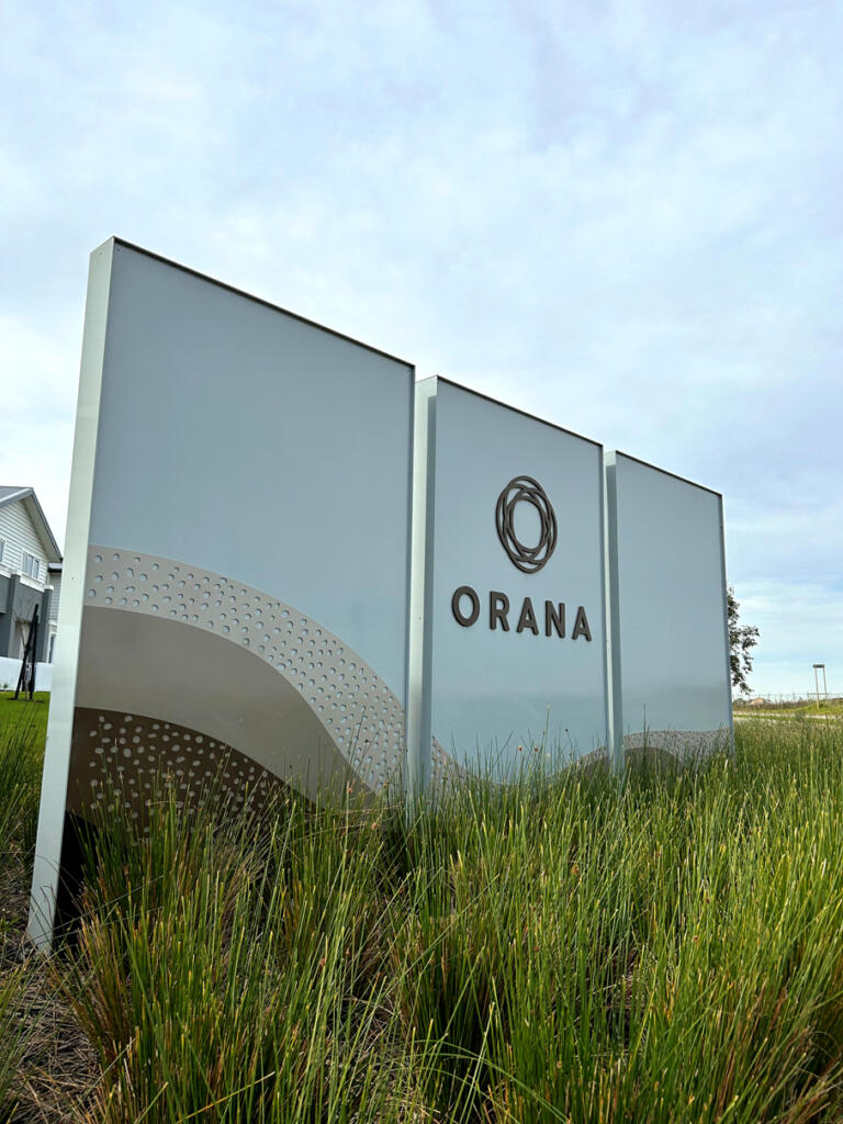 Custom 3D Orana by Balcon signage by Lump Sculpture Studio, creating a bold landmark at the community entrance opposite the Nest sculptures.