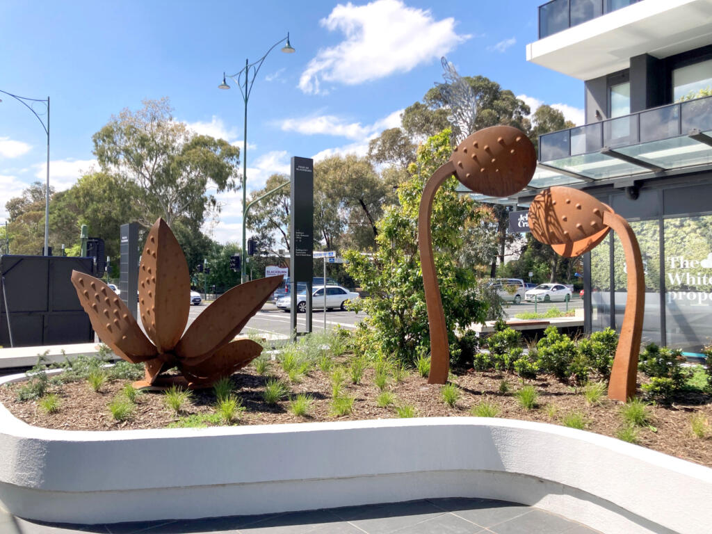 Large rusted steel sculptures depicting seedlings with new sprouts diplayed at the Pace Building in Blackburn