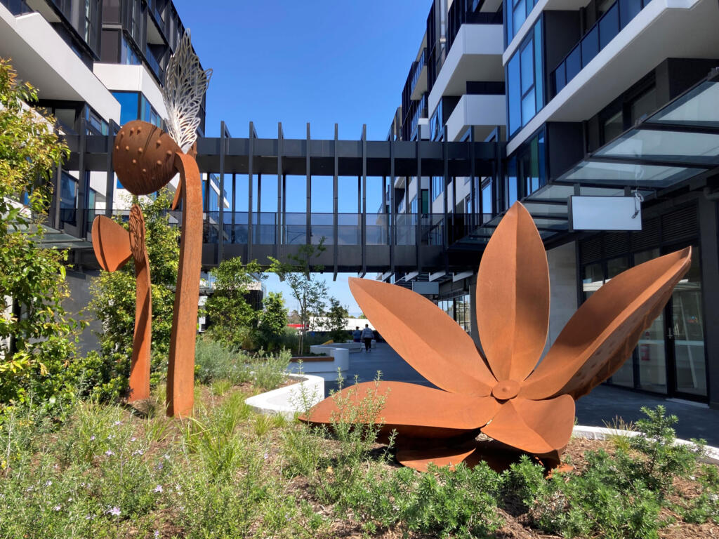 Large rusted steel sculptures depicting seedlings with new sprouts diplayed at the Pace Building in Blackburn