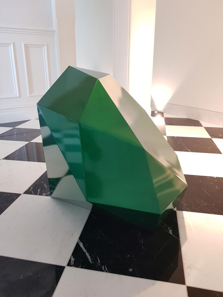 Large sculpture of a round brilliant cut Emerald gemstone;