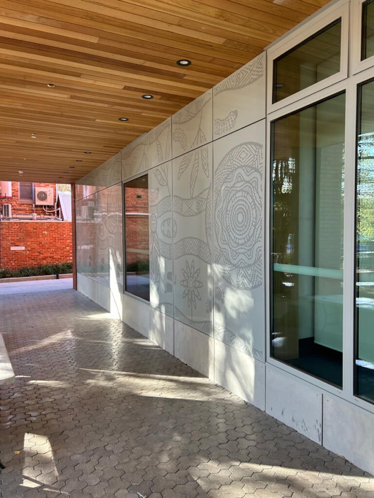 Mural made from perforated aluminium honouring the Wurundjeri People of the Kulin Nations representing children’s education and life's journey designed by Dixon Patten fabricated by Lump Studio installed at Preston South Primary School