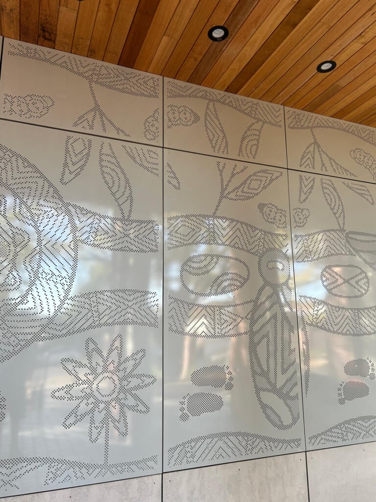 Mural made from perforated aluminium honouring the Wurundjeri People of the Kulin Nations representing children’s education and life's journey designed by Dixon Patten fabricated by Lump Studio installed at Preston South Primary School