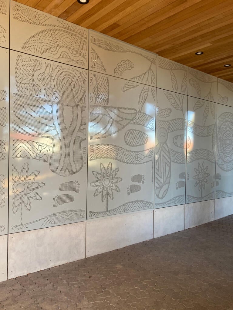 Mural made from perforated aluminium honouring the Wurundjeri People of the Kulin Nations representing children’s education and life's journey designed by Dixon Patten fabricated by Lump Studio installed at Preston South Primary School