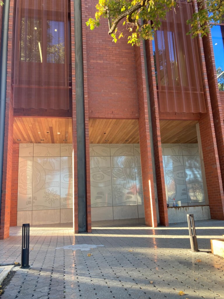 Mural made from perforated aluminium honouring the Wurundjeri People of the Kulin Nations representing children’s education and life's journey designed by Dixon Patten fabricated by Lump Studio installed at Preston South Primary School