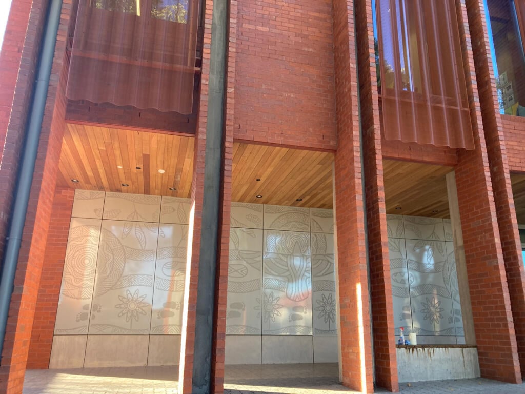 Mural made from perforated aluminium honouring the Wurundjeri People of the Kulin Nations representing children’s education and life's journey designed by Dixon Patten fabricated by Lump Studio installed at Preston South Primary School