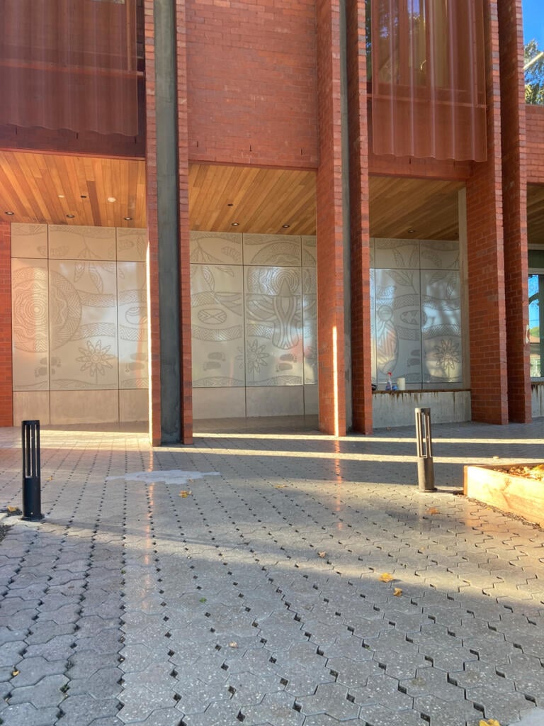Mural made from perforated aluminium honouring the Wurundjeri People of the Kulin Nations representing children’s education and life's journey designed by Dixon Patten fabricated by Lump Studio installed at Preston South Primary School