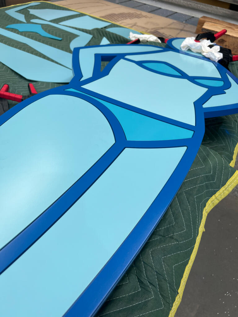 Two Blue Sun Bathers designed by Stephen Baker are new sculptures fabricated by Lump Studio installed by the pool at Le Méridien Melbourne