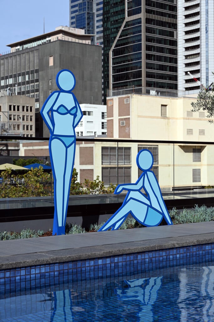 Two Blue Sun Bathers designed by Stephen Baker are new sculptures fabricated by Lump Studio installed by the pool at Le Méridien Melbourne
