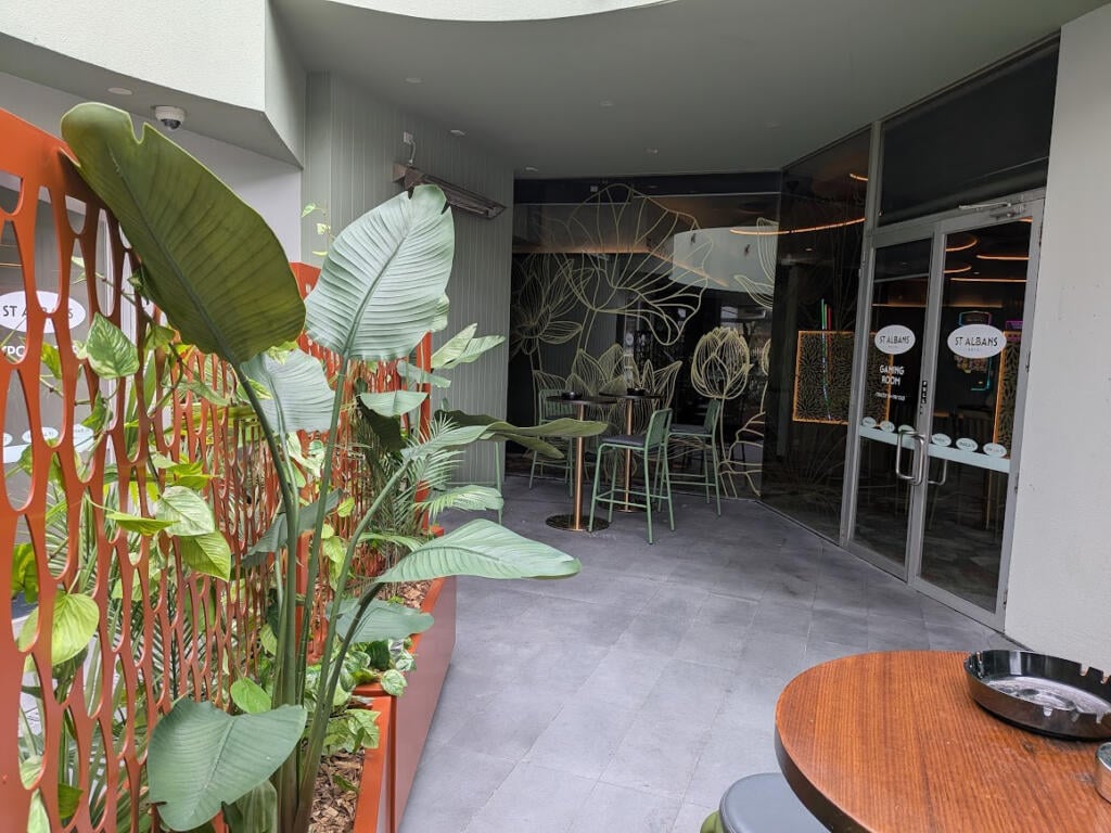 Custom Corten steel planter with drop-in pot system allowing individual potted native plants to be easily removed and replaced.